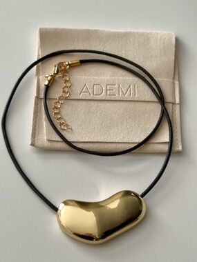 Gold Bean Pendant Necklace on Black Cord